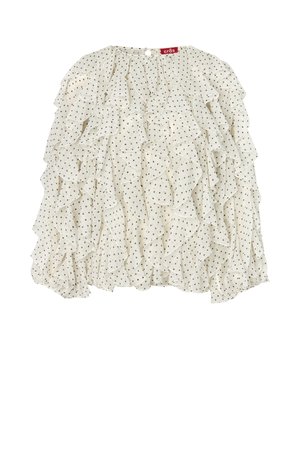 Balta blūze ar garām piedurknēm un melniem punktiņiem, dekorēta ar slāņainiem volāniem priekšpusē un piedurknēs, kā arī nelielu pogas aizdari kakla aizmugurē.