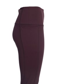 Höga, mörk lila leggings av elastiskt tyg med platta sömmar och en mjuk yta. Inga synliga mönster eller detaljer.