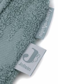 Tissu bleu clair texturé avec un motif strié ; comprend deux étiquettes : l'une grise avec "Jollein" et l'autre avec "nijntje.miffy."