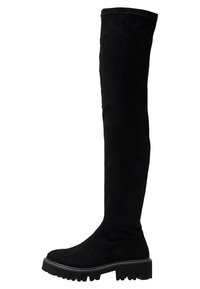 Bottes noires au-dessus du genou en daim avec une semelle plate et épaisse et une finition texturée. Présentent un design élégant et une couture minimaliste.