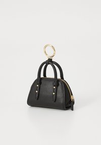 Black textured mini handbag keychain with two handles and a gold zipper, attached to a round gold keyring on a white background.