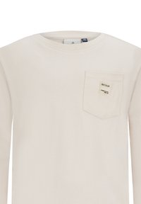 Lichtbeige langemouwen shirt van katoen. Beschikt over een borstzak met een label, ronde halslijn en een gladde textuur.