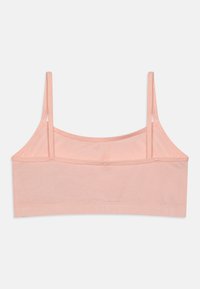 Lyserød bralette med tynde stropper, lavet af blødt stof. Har en simpel, lige skæring og et elastisk bånd forneden.