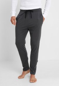 Grijze, lichtgewicht joggingbroeken met een trekkoord in de taille, slim fit en zijzakken. Zachte textuur, taps toelopend ontwerp en geen zichtbare patronen.
