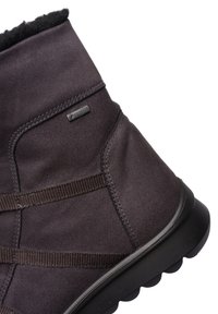 Bota de tobillo marrón impermeable de Gore-Tex con un suave forro de felpa, que cuenta con correas elásticas y una suela de goma texturizada para mayor agarre.