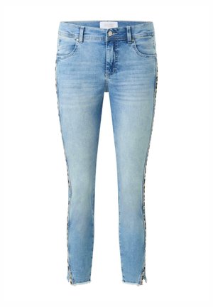 Light blue skinny jeans with a distressed finish, featuring unique patterned side stripes and raw hem details at the ankles.