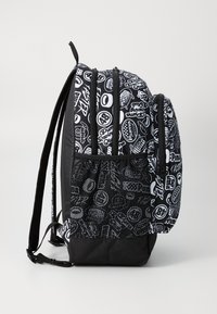 Black backpack with white abstract graphic patterns, zippered compartments, mesh side pocket, and padded shoulder straps. Textured fabric.