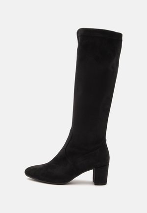 Black knee-high suede boot with a pointed toe and block heel, shown in profile on a plain white background.