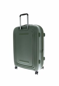 Valigia rigida verde con scanalature verticali, maniglia retrattile e quattro ruote per la mobilità. Chiusura con zip e dettagli di presa laterale.