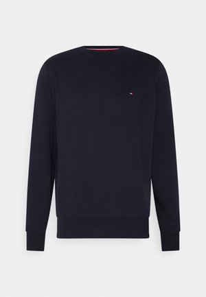 Marineblaues Sweatshirt mit Rundhalsausschnitt, langen Ärmeln und einem kleinen rot-weiß-blauen Logo auf der linken Brust.
