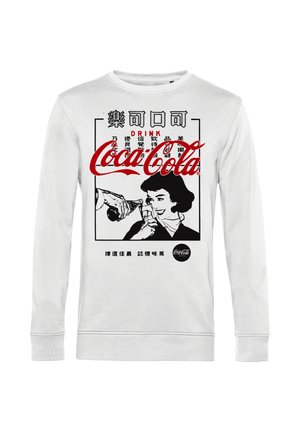 Sweatshirt blanc à manches longues avec un motif rétro de Coca-Cola. Le design comprend du texte noir et une illustration d'une femme buvant dans une bouteille.