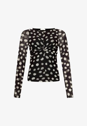 Zwart langwerpig shirt met een wit stippenpatroon, voorzien van een twist aan de voorkant en doorschijnende mouwen voor een gestructureerd uiterlijk.