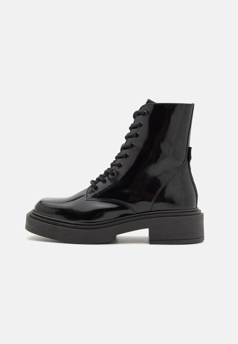 Black patent leather ankle boots with a chunky black sole, featuring lace-up detail and a smooth, glossy finish.
