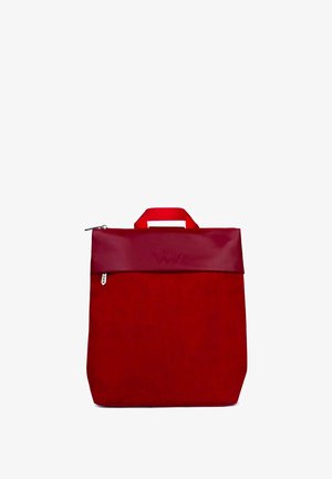 Red tote bag with a textured body and a smooth, glossy top flap. Features a short handle and zip closure. Charming brand logo embossed on top.