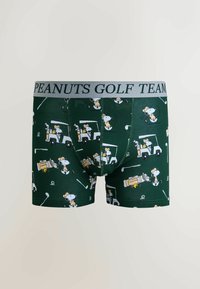 Gröna boxershorts med ett mönster av tecknade figurer som spelar golf. Grå midjeresår med texten "PEANUTS GOLF TEAM". Mjukt, elastiskt material.