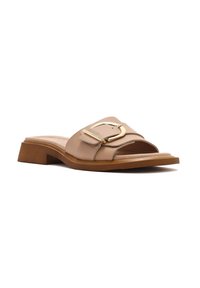 Nude slide sandal with a wide strap, metallic buckle accent, medium-block heel, and a smooth leather finish.