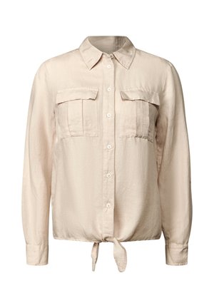 Lichtbeige overhemd met lange mouwen, twee voorzakken en een gestrikt detail in de taille. Gemaakt van een zachte, textuurstof.