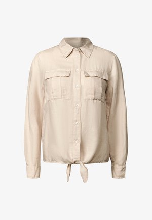 Lichtbeige overhemd met lange mouwen, twee voorzakken en een gestrikt detail in de taille. Gemaakt van een zachte, textuurstof.