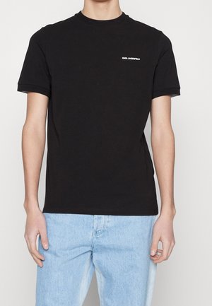 T-shirt en coton noir à manches courtes et col rond. Présente un petit logo blanc sur la poitrine. Texture lisse, coupe normale.
