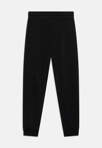 Svarta sweatpants i mjukt tyg. Har elastisk midja, smalnande ben och subtila vinklade sömmar för en strömlinjeformad look.