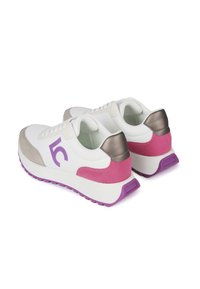 White athletic shoes with grey, pink, and metallic accents. Thick white soles with purple traction, featuring a logo on the side.