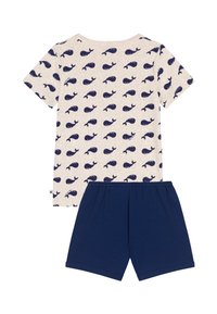 Μπλούζα με κοντά μανίκια σε μπεζ χρώμα με σχέδιο ναυτικού φάλαινας σε ναυτικό μπλε και σορτς σε ναυτικό μπλε. Υλικό από βαμβάκι, casual εφαρμογή με απαλή υφή και ελαστική μέση.