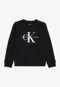 Černá mikina s kulatým výstřihem a dlouhými rukávy. Na přední straně je velké bílé logo "CK" a text "CALVIN KLEIN JEANS".