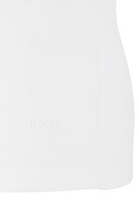 White cotton t-shirt featuring a round neckline and a subtle tonal embroidered logo reading "BOSS" near the hem. Soft, smooth texture.