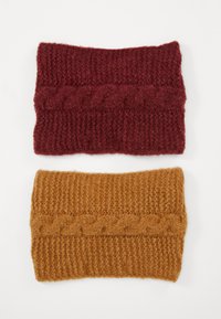 Knitted headbands in burgundy and mustard yellow, featuring a cable design, textured ribbing, and soft, thick fabric.