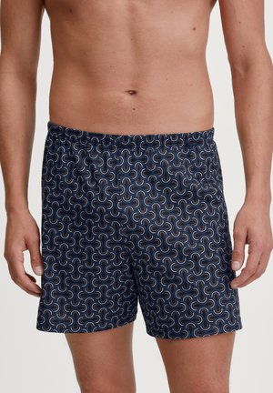 Marinefarbene Schwimmshorts mit einem sich wiederholenden Muster aus bunten, geschwungenen Formen; aus leichtem Stoff mit einem elastischen Bund.