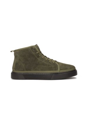 Green suede high-top sneakers with a thick black rubber sole, round toe, lace-up design, and a pull tab at the back for easy wear.