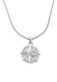 Pendentif en argent en forme de compas sur une chaîne métallique. Le pendentif présente un cercle central et des pointes acérées, avec une bordure texturée. La chaîne est lisse.