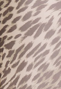 Beige fabric with irregular brown and taupe brushstroke patterns resembling animal print, flowing diagonally across the surface.