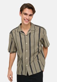 Short-sleeve button-up shirt in light brown with dark vertical stripes, featuring a standard collar and textured fabric.