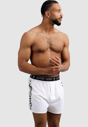 White boxer shorts with black elastic waistband featuring "LOUSY LVN" text. The fabric appears smooth and lightweight.