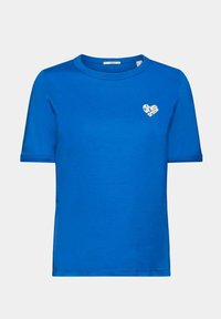 T-shirt bleu royal à manches courtes avec un petit texte en forme de cœur blanc sur le côté gauche de la poitrine indiquant « TOUT CE DONT NOUS AVONS BESOIN, C’EST D’UN AMI. »