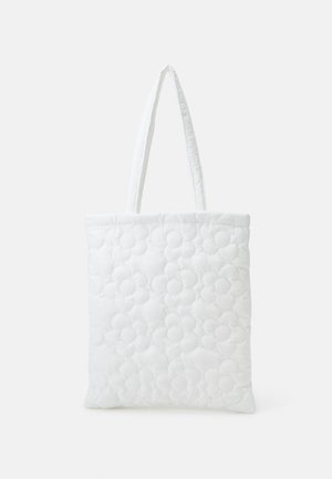 Quilted white tote bag with flower pattern, featuring two sturdy fabric handles and a soft, padded texture throughout.