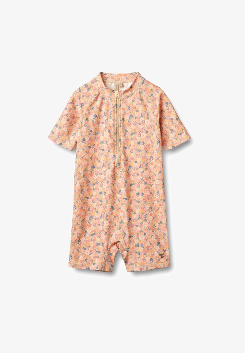 Korte mouwen, ritssluiting rompertje in lichtroze met een bloemenpatroon van kleine blauwe en gele bloemen. Gemaakt van zachte, rekbare stof.