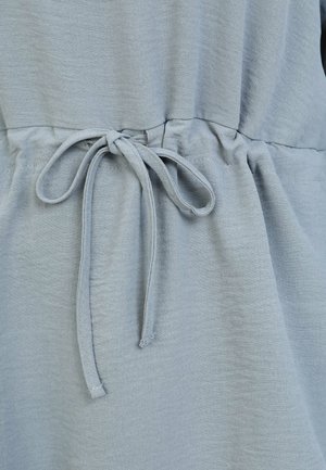 Light blue garment with a gathered waist and a fabric tie. The texture appears soft and slightly wrinkled, highlighting a casual design.