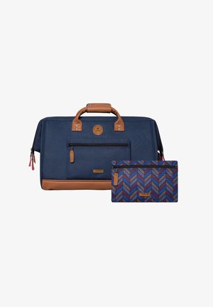Navy fabric duffel bag with brown leather accents, front zip pocket, and a removable patterned pouch featuring a chevron design in shades of blue and red.