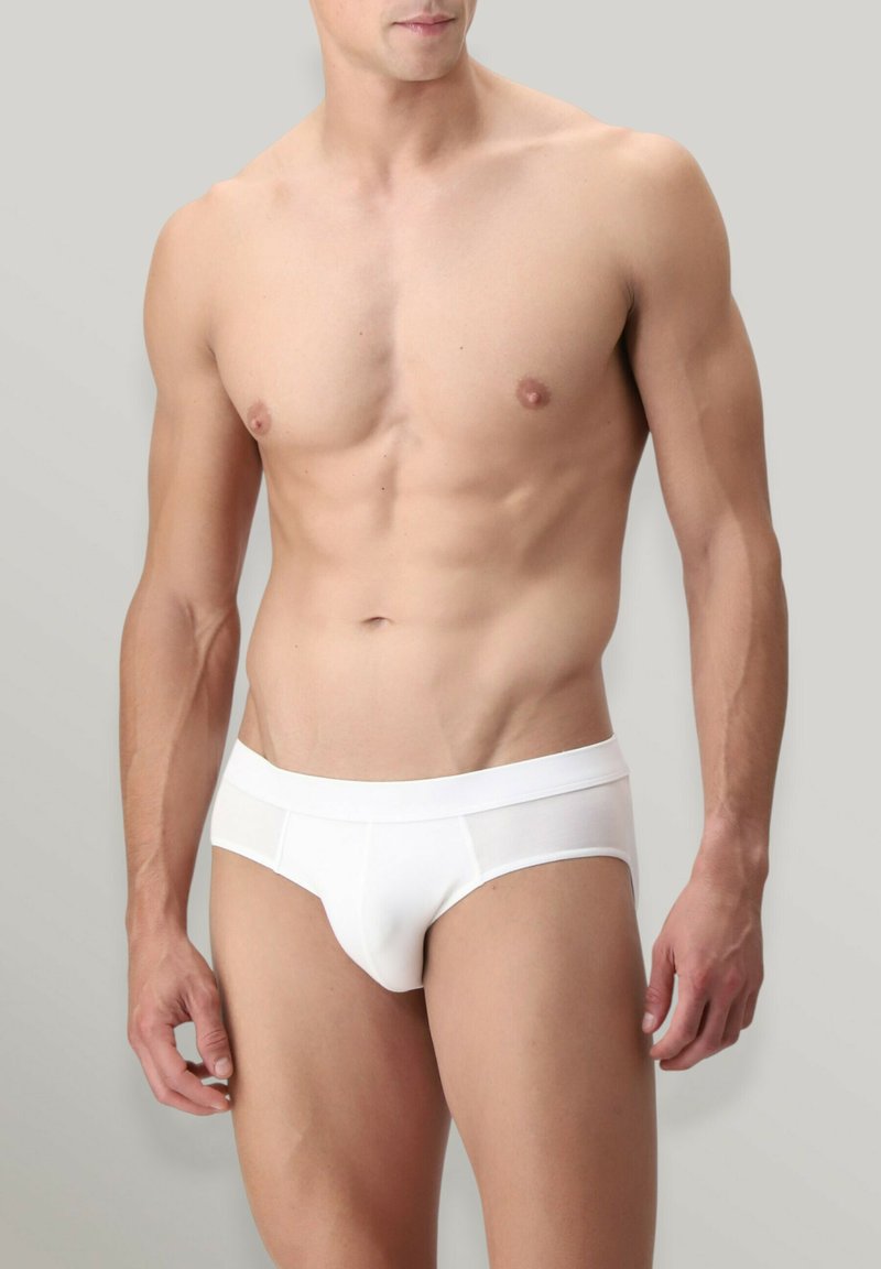 Slip di cotone bianco caratterizzati da una texture liscia e una vita elastica. Progettati con un taglio basso e minime cuciture per il massimo comfort.