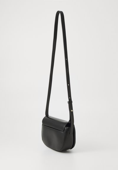 Black leather crossbody bag with a smooth texture, rounded shape, and adjustable strap; features a flap closure and minimalistic design.