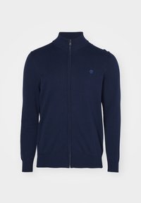 Suéter de cremallera azul marino con un cuello alto, hecho de un tejido de punto suave, con mangas largas y un pequeño logotipo sutil en el pecho.