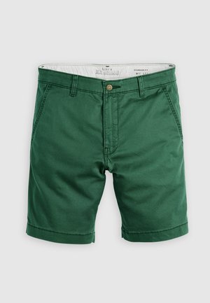 Groene chino shorts met een standaard pasvorm, gemaakt van katoen, met een knoopsluiting en opgerolde manchetten. Gladde textuur met zijzakken.