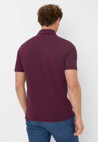 Polo shirt bordeaux in cotone, maniche corte, colletto classico, tessuto liscio, con orlo dritto e stile casual.