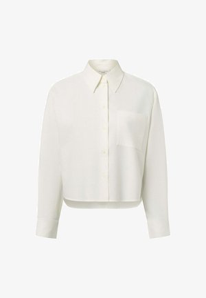 White cropped shirt with a collared neckline, long sleeves, a single chest pocket, and button front closure. Made from a soft, textured fabric.