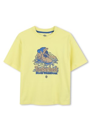 Gele katoenen t-shirt met een blauwe grafiek van laarzen en de tekst "Timberland Boots With Roots." Korte mouwen en een relaxte fit.
