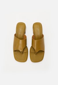Brown leather slide sandals with a square toe, wide strap design, and a small heel. "CAMPER" embossed on footbed. Smooth texture.