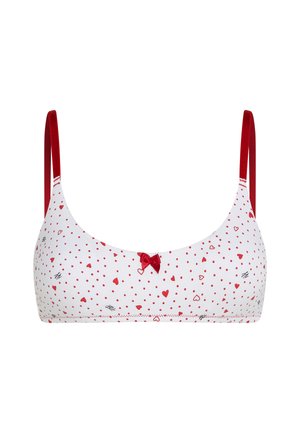 Hvid bralette med rødt hjerte- og prikmønster, røde justerbare stropper og lille rød sløjfedetail foran i midten.