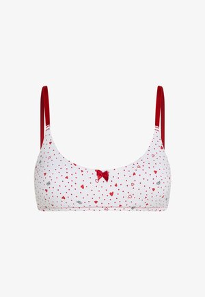 Balti liemenėlė su raudonų širdelių ir taškų raštu, raudonais reguliuojamais dirželiais ir maža raudona juostele priekyje.